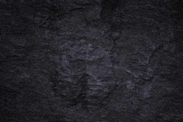 istock Dark grey black slate background or natural black stone texture 1140697326