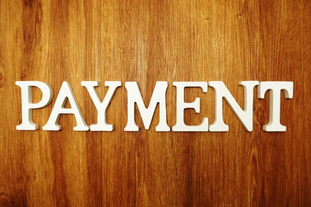 istock Payment word alphabet letters on wooden background 1140702870
