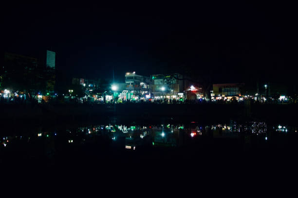 istock People sitting around a park at night 1140710142