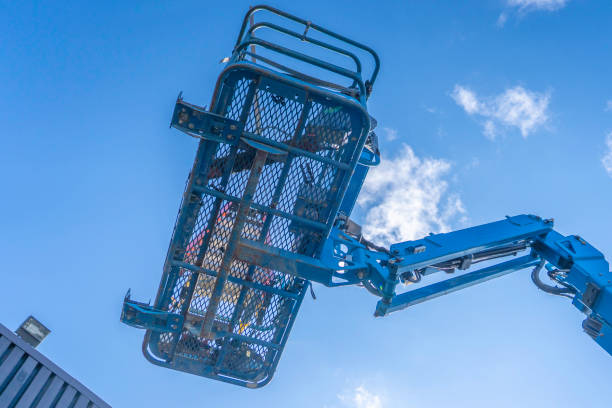istock Cherry Picker Crane Underneath blue clear skies 1140710267
