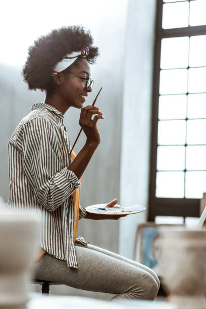istock Beaming student feeling satisfied with her work after painting 1140711060