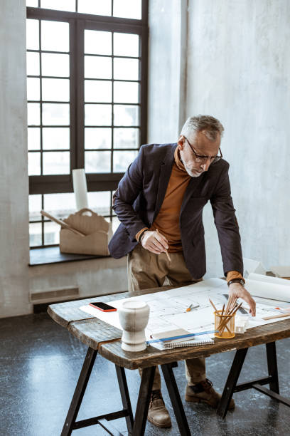 istock Bearded interior designer wearing glasses working hard 1140711112