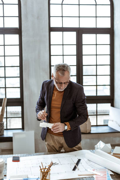 istock Interior designer wearing nice hand watch looking at sketches 1140711124