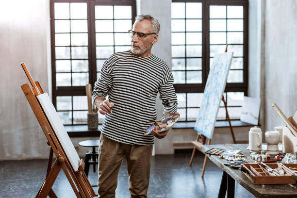 istock Bearded artist feeling amazing while painting new masterpiece 1140711148