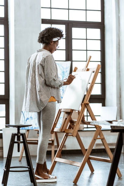 istock Young artist feeling truly inspired standing near drawing easel 1140711172