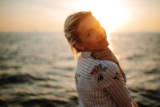 istock Smiling blonde by the sea 1140712587