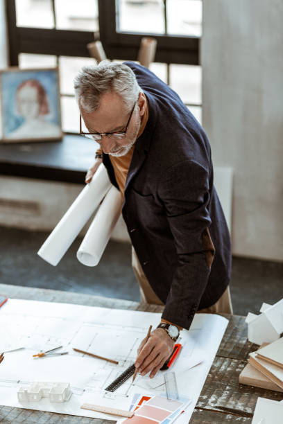 istock Interior designer using rulers and pencils finishing sketches 1140713556