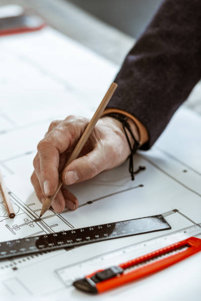istock Architect wearing black bracelet making some sketches 1140713559