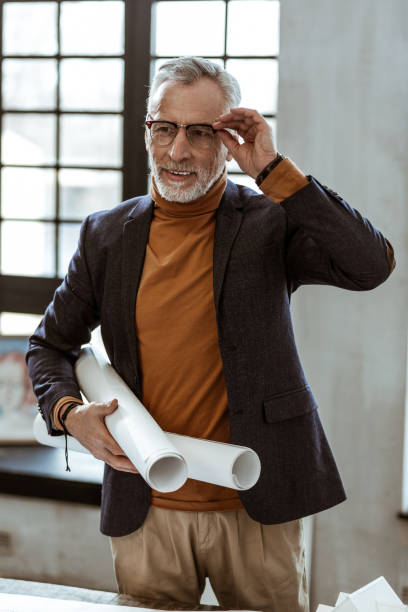 istock Interior designer holding map papers with plans for the apartment 1140713560