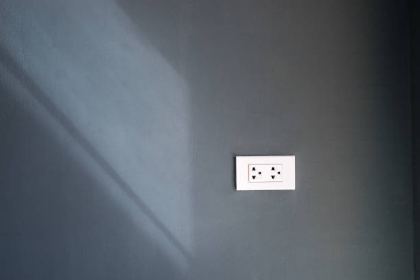 abstract plug on dark wall with light pass from window - can use to display or montage on product abstract plug on dark wall with light pass from window - can use to display or montage on product dimmer switch photos stock pictures, royalty-free photos & images