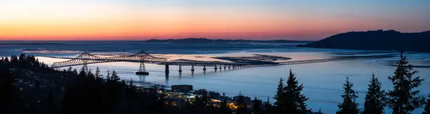 A panoramic evening look at the bridge spanning the Columbia River from Oregon to Washington State. This is the Astoria–Megler Bridge. Crosses from Astoria Oregon to near Megler, Washington. Is unusually long at a little over 4 miles.