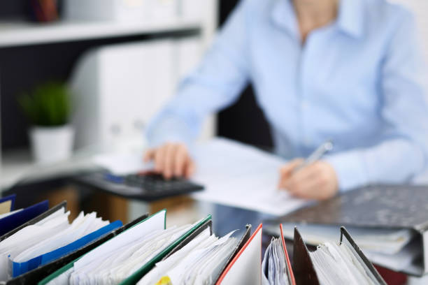 istock Unknown bookkeeper woman or financial inspector  making report, calculating or checking balance, close-up. Business portrait. Audit or tax concepts 1140721944