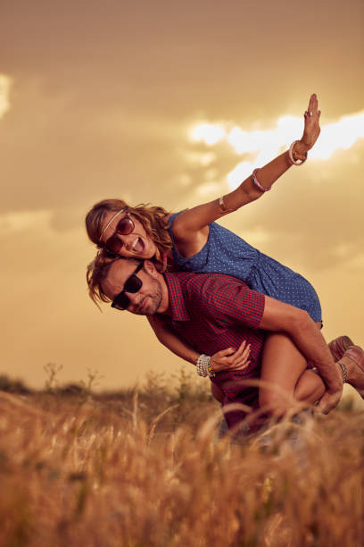 istock Couple in sunset / sunrise time in a wheat field. 1140725357