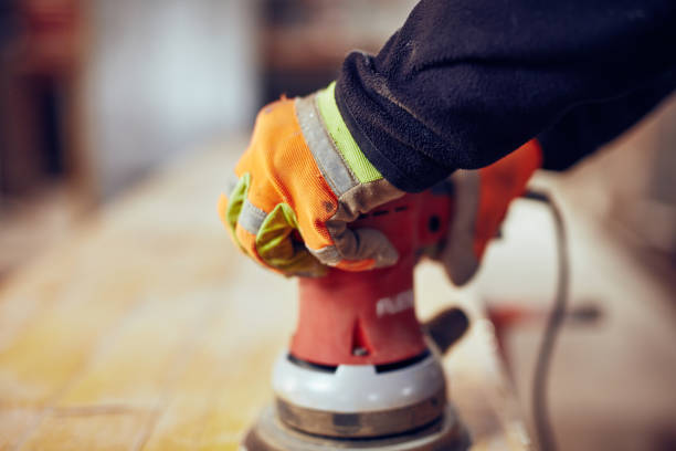 istock Male carpenter using orbital electric sander in a retro vintage workshop. 1140727486