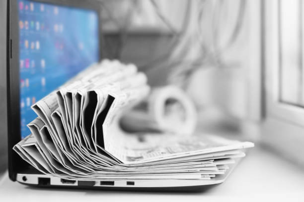 istock Laptop and Newspapers 1140727695