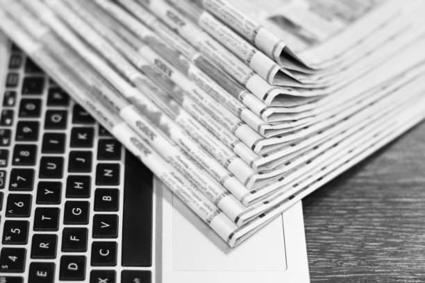 istock Newspapers and Laptop 1140728181
