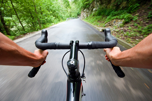 Road cycling wide angle speed shoot in nature. Landscape cycling in road