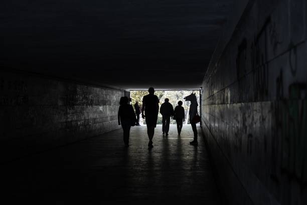 istock Silhouette People Walking In Tunnel 1140736431