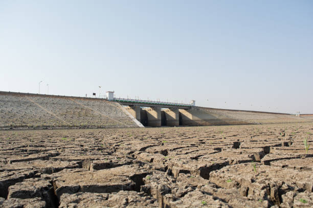 A dried up empty reservoir or dam during a summer heatwave, low rainfall and drought in north karnataka,India A dried up empty reservoir or dam during a summer heatwave, low rainfall and drought in north karnataka,India. reservoir stock pictures, royalty-free photos & images