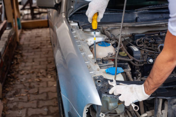 istock mechanic men with wrench repairing car engine at 1140738363