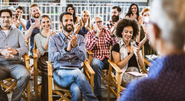 istock Panoramic view of happy entrepreneurs applauding on training class. 1140742361