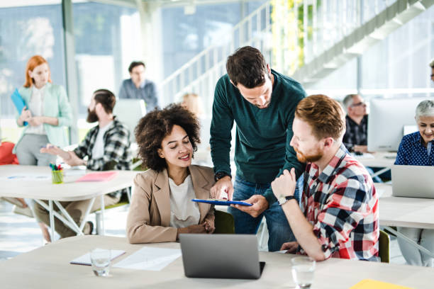 istock Young happy freelancers working on reports in a modern office. 1140743052