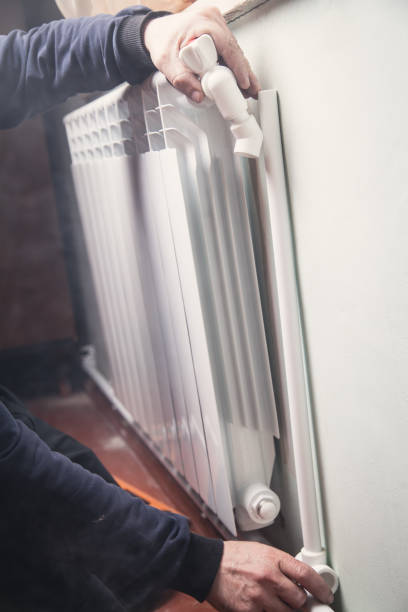 istock Installation and connection of new hot water radiator. 1140743236