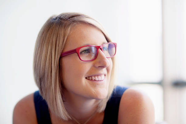 istock Woman with red glasses looking sideways in office 1140743374