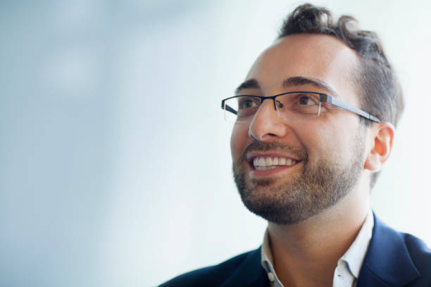 istock Man with glasses looking ahead in office meeting 1140743774