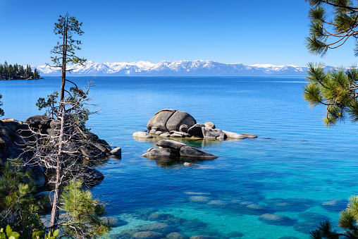 Panorana view of Deep Blue and Turquoise Water at Lake Tahoe with snowcapped mountain in early summer, Nevada, USA