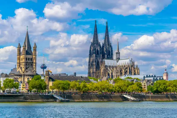 Photo of Cityscape of Cologne with Hohenzollern bridge, cathedral and Saint Martin church, Germany