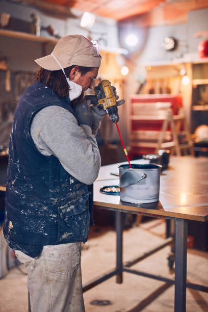 istock Male carpenter working on old wood in a retro vintage workshop. 1140746316