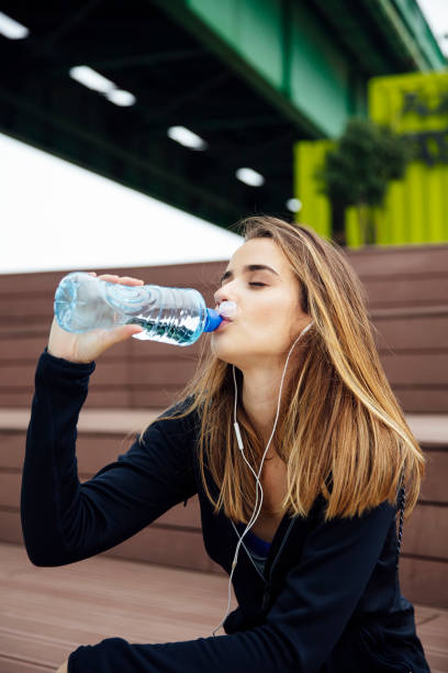 istock Young beautiful women resting and drinking water after doing exercises 1140747907