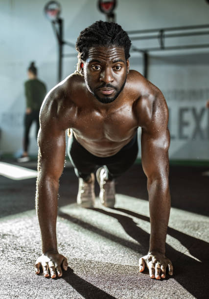 istock African American athlete exercising push-ups in a gym. 1140748262