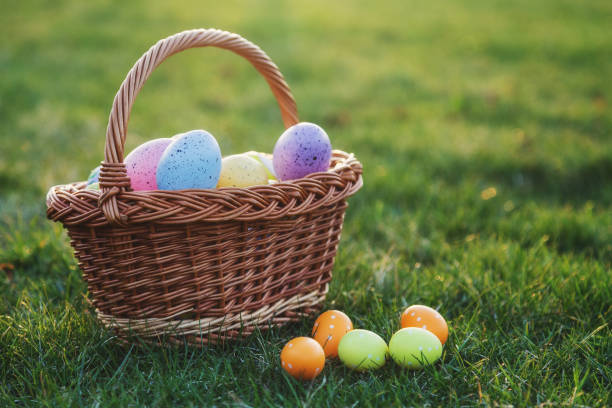 istock Basket full of easter eggs on green lawn 1140748312