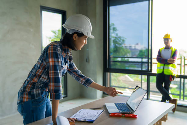 istock woman civil architech engineer discuss or brain stroming work with collegue ,engineering and architecture concept.Blue print is fake only for stock photo. 1140749154