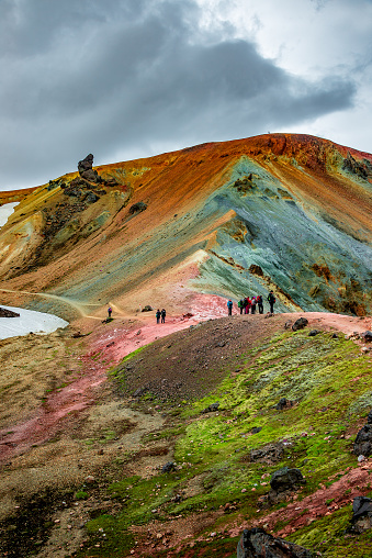Beautiful colorful volcanic mountains Landmannalaugar and hikers on trail, Iceland, summer time