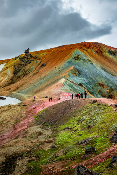 Beautiful colorful volcanic mountains Landmannalaugar and hikers on trail, Iceland stock photo