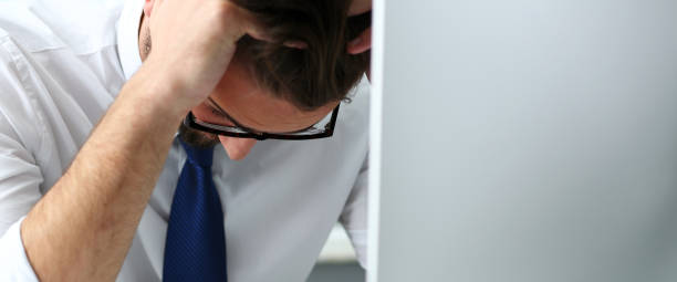 istock Tired clerk at laptop pc workplace wearing glasses 1140749561