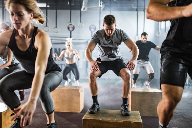 istock Athletic people exercising jumps on crates during cross training in a gym. 1140749730