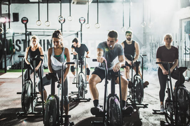 istock Athletic people taking a break from exercising on stationary bikes in a gym. 1140750348