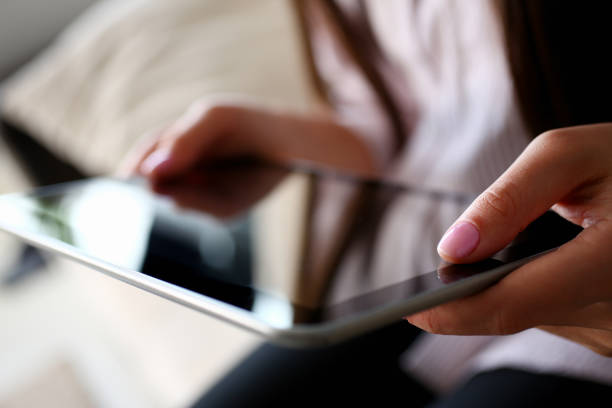 istock female hand holds tablet in home setting while 1140750670