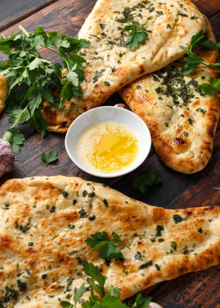 istock Indian naan bread with garlic butter on wooden table 1140752761
