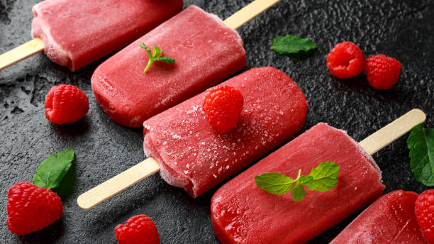 istock Homemade raspberry popsicles, ice lolly on rustic black background 1140753520