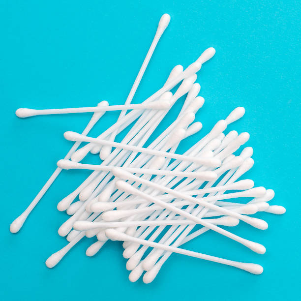 istock White cotton buds scattered on blue background 1140753682
