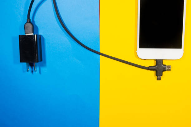 istock A charging phone connected with adapter block through black cable 1140755699