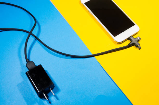 istock A charging phone connected with adapter block through black cable 1140755750