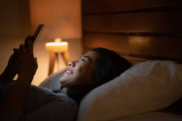 istock asian woman with smart phone while laying on bed 1140755896