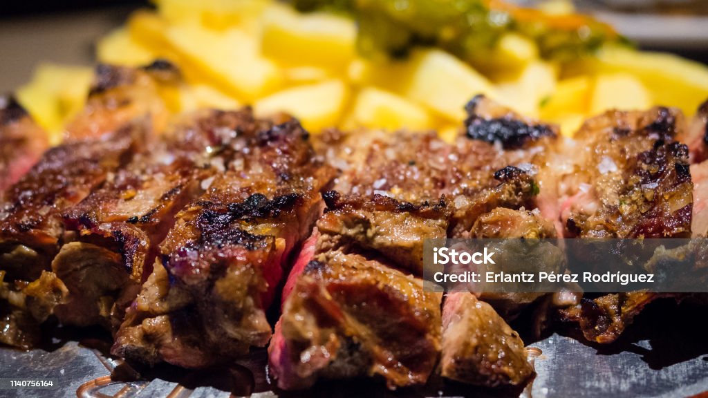 Close-up detail of a beef rib grilled with fried potatoes, Spanish food Cooked Stock Photo