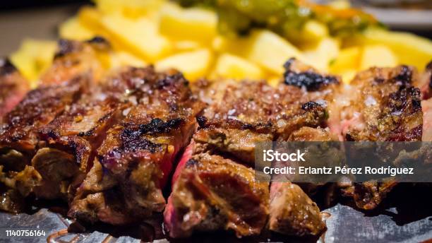 Closeup Detail Of A Beef Rib Grilled With Fried Potatoes Spanish Food Stock Photo - Download Image Now